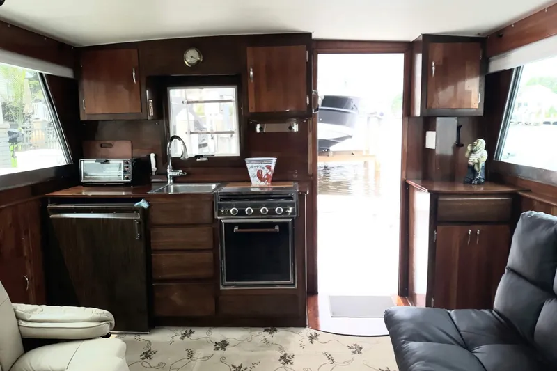 Slide: The Image of Interior of a 1968 Hatteras 38 Convertible yacht with wooden cabinetry and modern appliances. - 3