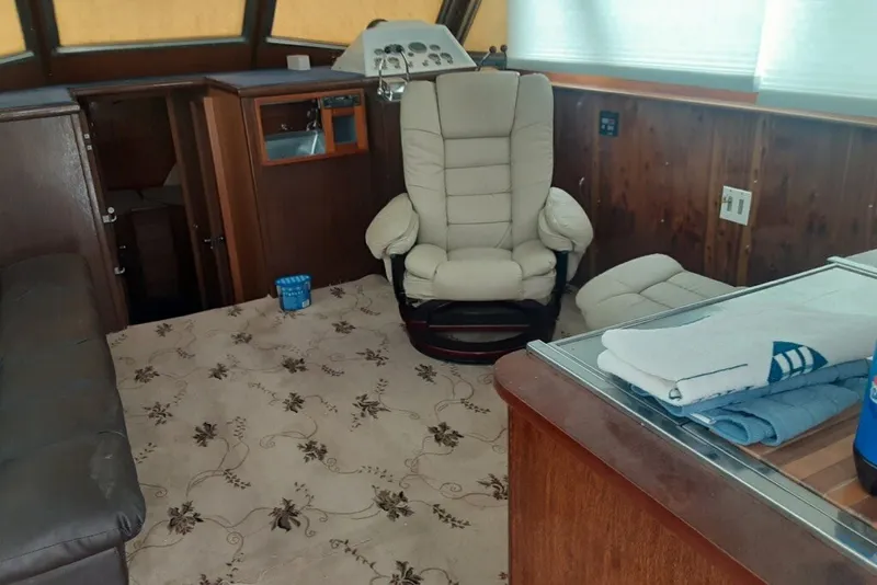 Slide: The Image of Interior of 1968 Hatteras 38 Convertible yacht with beige chair and floral carpet. - 7