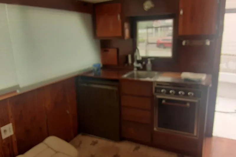 Slide: The Image of Interior of 1968 Hatteras 38 Convertible yacht kitchen with wood cabinetry and appliances. - 8