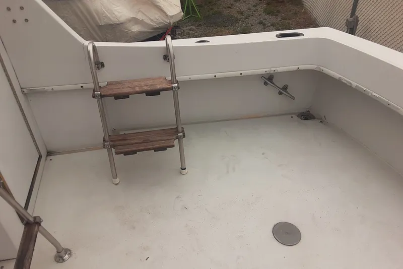 Slide: The Image of 1968 Hatteras 38 Convertible boat deck with ladder and clean white surface. - 11