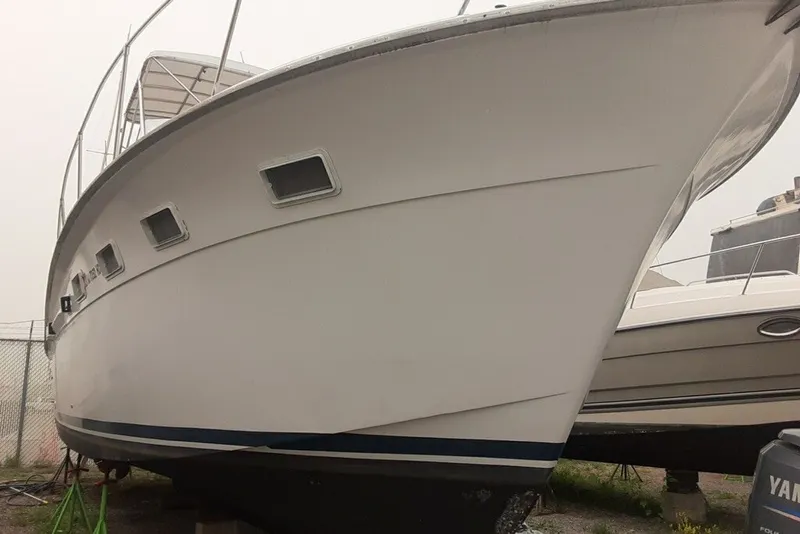 Slide: The Image of 1968 Hatteras 38 Convertible boat on dry dock, showcasing its classic design. - 13