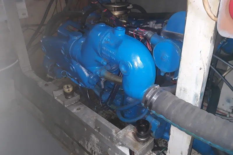 Slide: The Image of Engine compartment of a 1968 Hatteras 38 Convertible boat, featuring a blue engine. - 19