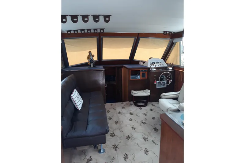 Slide: The Image of Interior of 1968 Hatteras 38 Convertible yacht with vintage helm and seating area. - 4