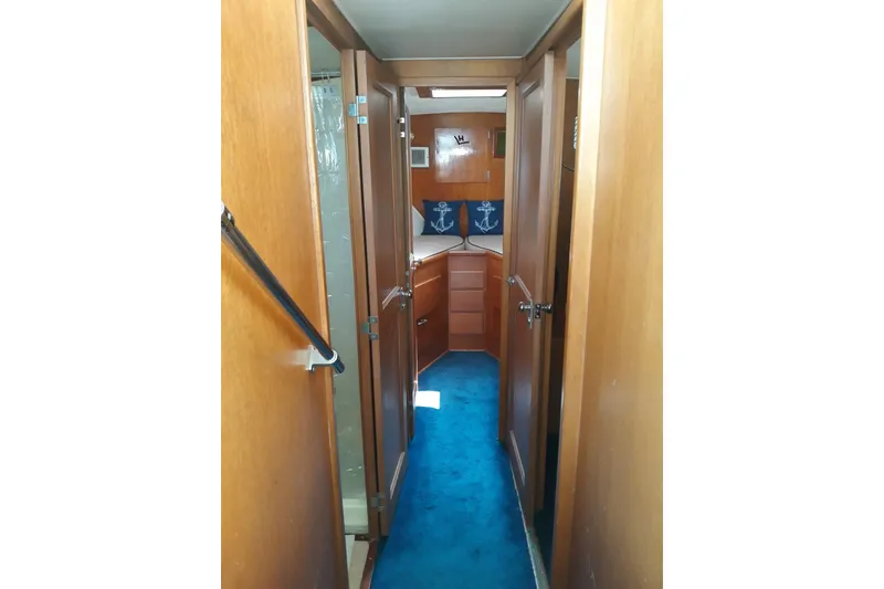 Slide: The Image of Interior hallway of a 1968 Hatteras 38 Convertible yacht with wooden paneling. - 6