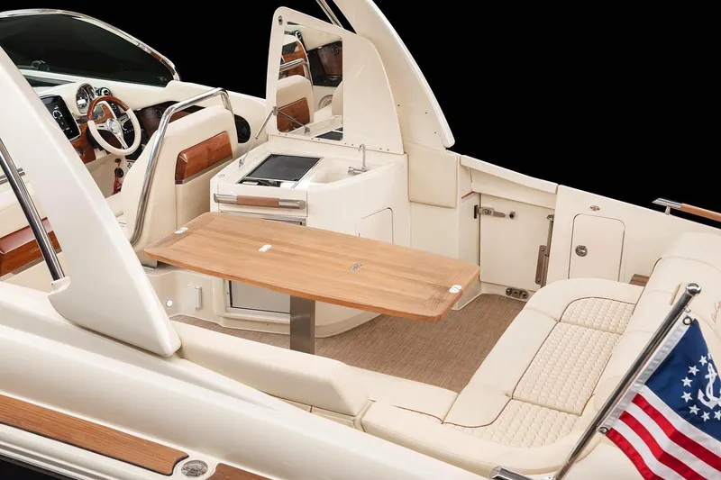 Slide: The Image of Chris-Craft Launch 31 GT 2023: Luxurious interior with elegant seating, wooden table, and modern controls. - 15