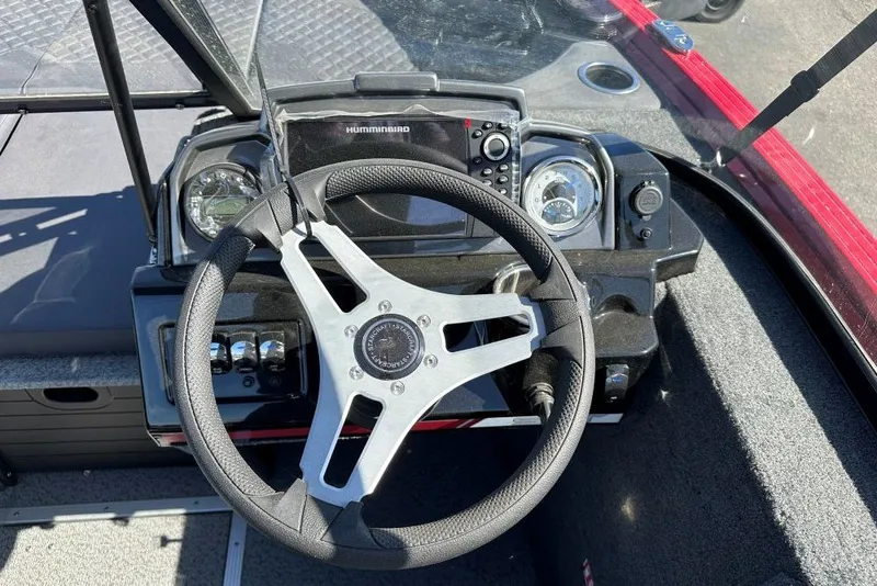 Slide: The Image of Steering wheel and dashboard of 2026 Starweld 18 SXT boat with navigation controls. - 8