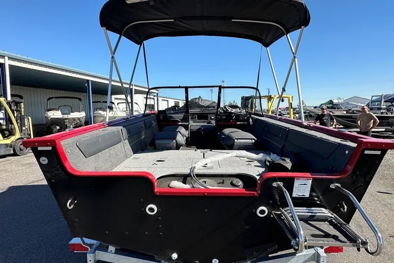 Slide: The Image of 2026 Starweld 18 SXT boat, rear view, showcasing spacious interior and canopy. - 4