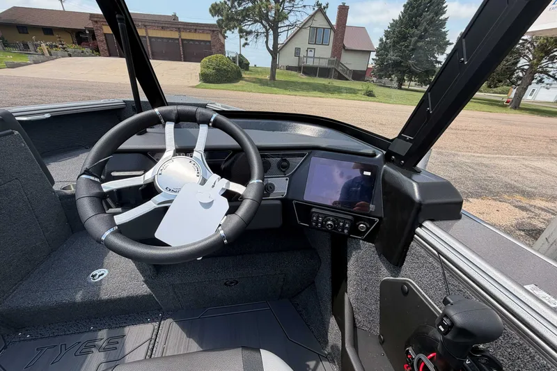 Slide: The Image of Interior of 2027 Lund 1975 Tyee boat with steering wheel and control panel. - 9