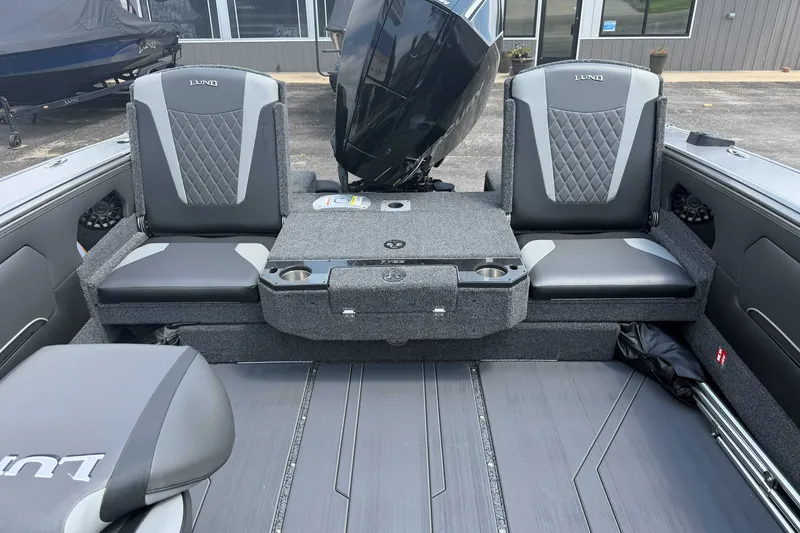 Slide: The Image of Interior of 2027 Lund 1975 Tyee boat with gray seating and storage compartments. - 5