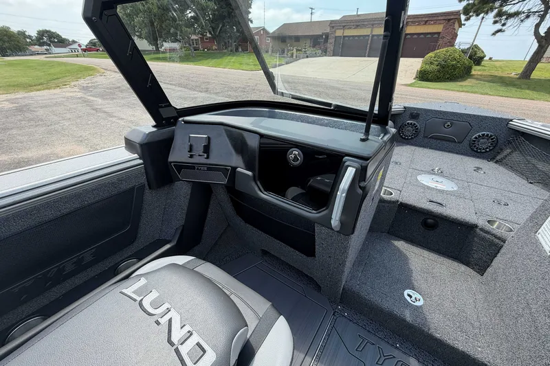 Slide: The Image of Interior of a 2027 Lund 1975 Tyee boat, showcasing seating and dashboard features. - 10