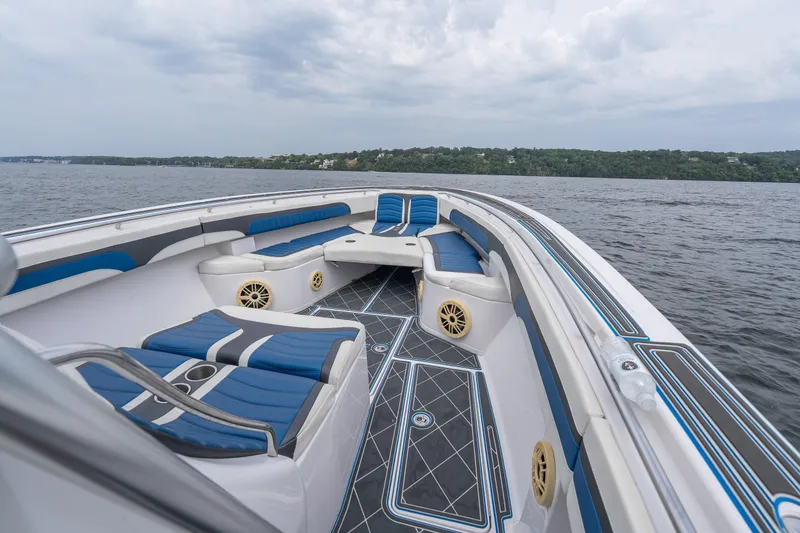 Slide: The Image of 2018 Fountain 38 Center Console boat with blue seating on a lake. - 13