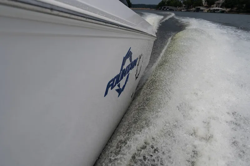Slide: The Image of 2018 Fountain 38 Center Console boat cruising on water, creating a dynamic wake. - 28