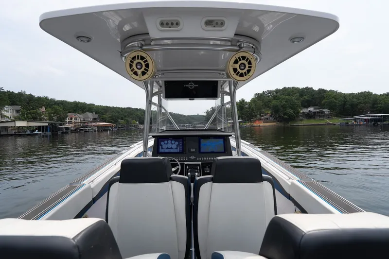 Slide: The Image of 2018 Fountain 38 Center Console boat interior with dual screens on a calm lake. - 39