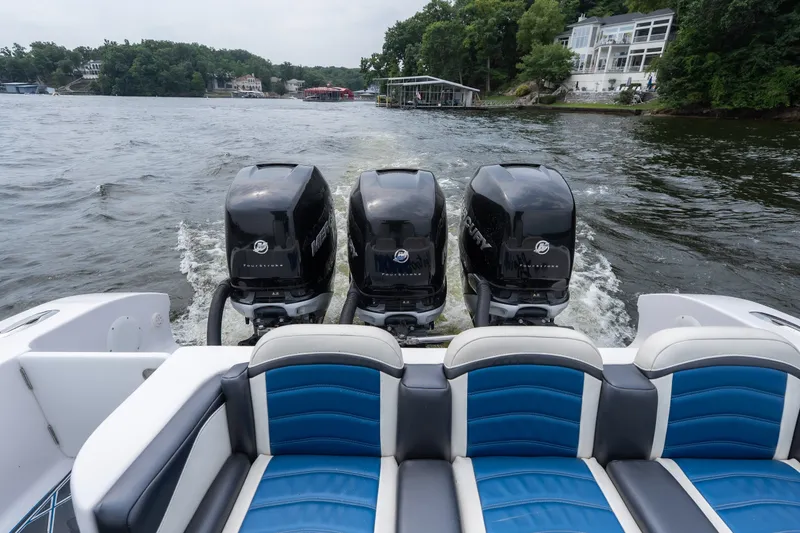 Slide: The Image of 2018 Fountain 38 Center Console boat with triple Mercury outboard engines on a lake. - 11