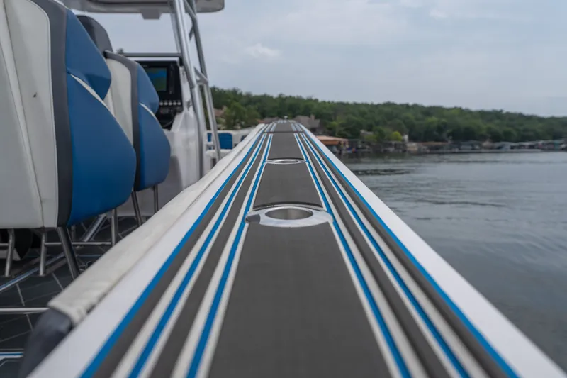 Slide: The Image of 2018 Fountain 38 Center Console boat interior with blue seating, lake view. - 47