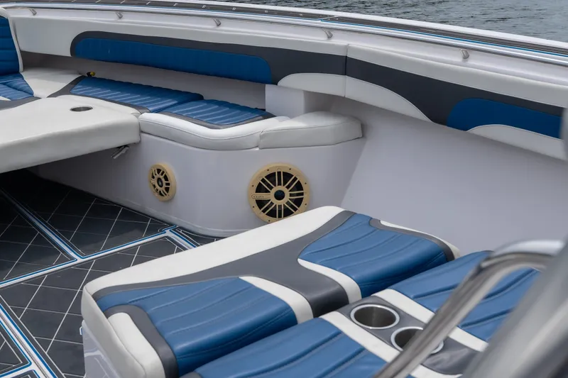 Slide: The Image of 2018 Fountain 38 Center Console boat interior with blue and white seating and cup holders. - 30