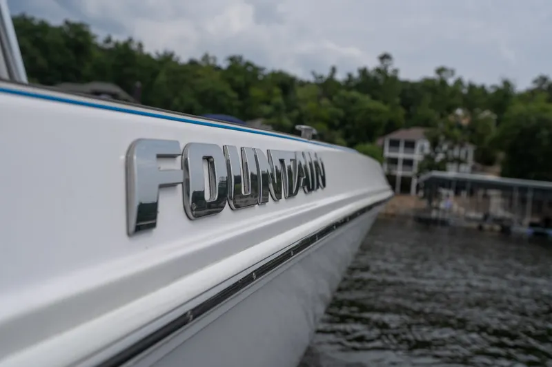 Slide: The Image of 2018 Fountain 38 Center Console boat on water, close-up of logo. - 49