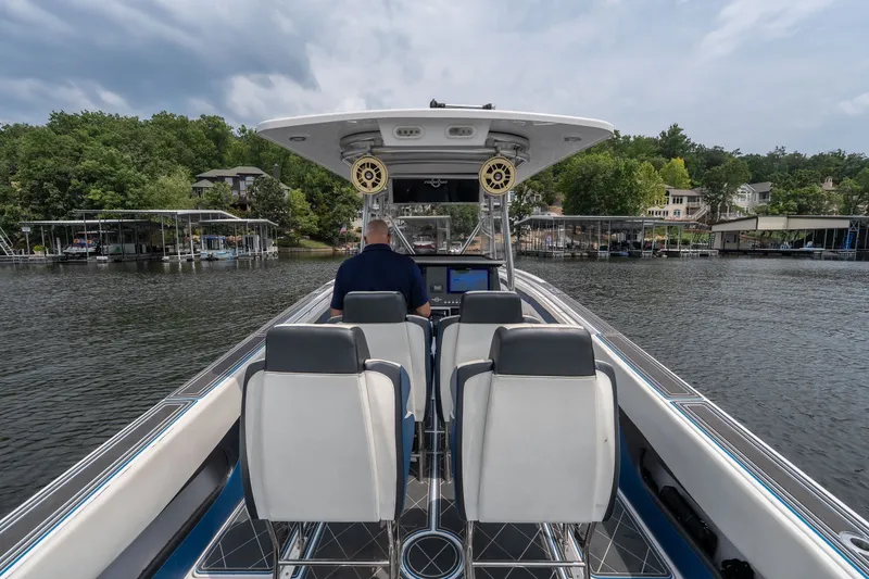 Slide: The Image of 2018 Fountain 38 Center Console boat on a lake, featuring modern seating and navigation. - 10