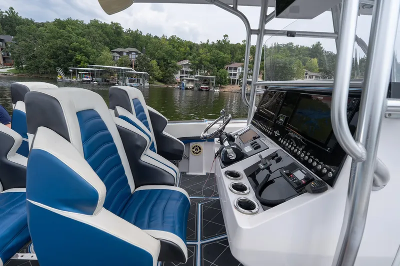 Slide: The Image of 2018 Fountain 38 Center Console boat interior with blue and white seating, advanced dashboard controls. - 44