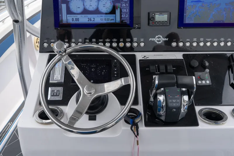 Slide: The Image of 2018 Fountain 38 Center Console helm with steering wheel and control panel. - 34