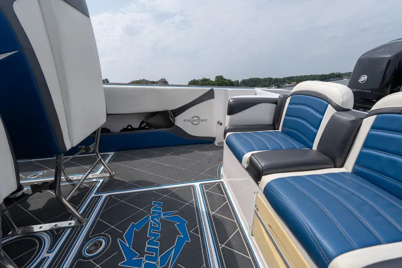 Slide: The Image of 2018 Fountain 38 Center Console boat interior with blue and white seating and logo flooring. - 27