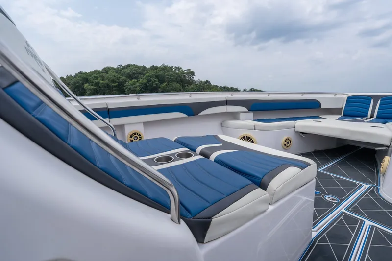 Slide: The Image of 2018 Fountain 38 Center Console boat interior with blue and white seating, open sky view. - 15
