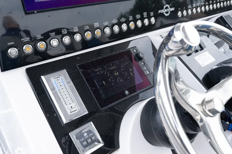 Slide: The Image of Control panel of a 2018 Fountain 38 Center Console boat with steering wheel. - 36