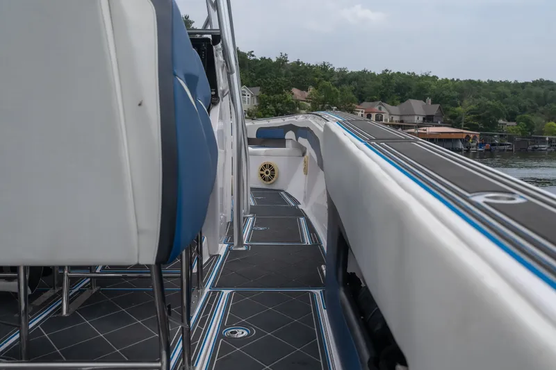 Slide: The Image of 2018 Fountain 38 Center Console boat interior with blue and white seating, dockside view. - 48