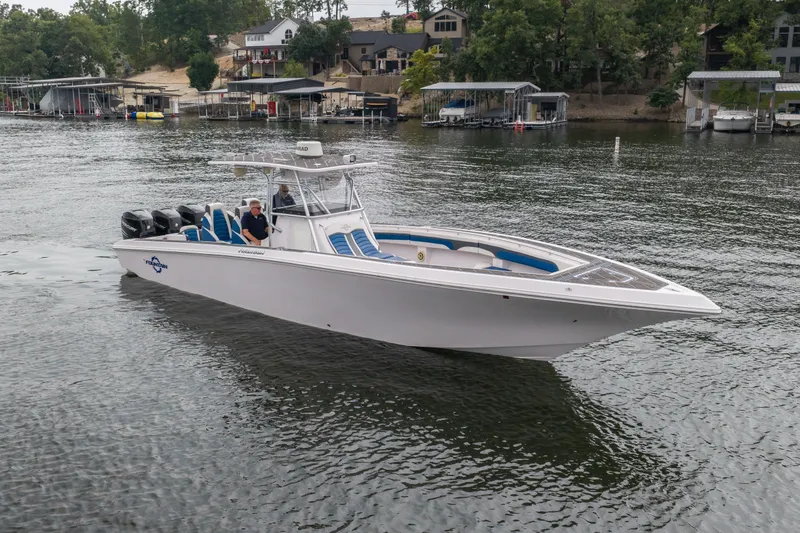 Slide: The Image of 2018 Fountain 38 Center Console boat cruising on a lake with scenic background. - 7