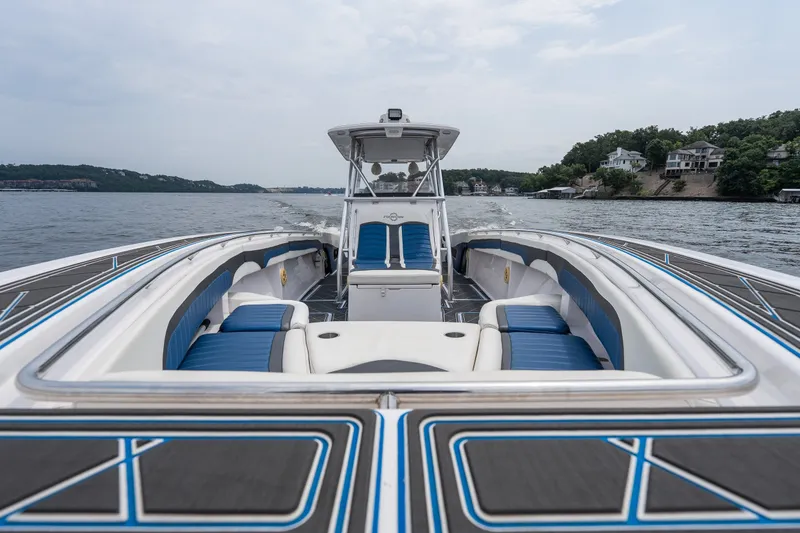 Slide: The Image of 2018 Fountain 38 Center Console boat cruising on a scenic lake. - 22