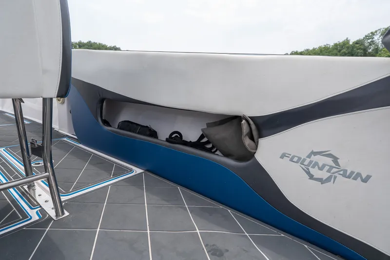 Slide: The Image of 2018 Fountain 38 Center Console boat interior with storage compartment and logo. - 41