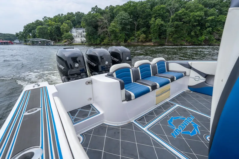 Slide: The Image of 2018 Fountain 38 Center Console boat with triple Mercury engines on a scenic lake. - 12