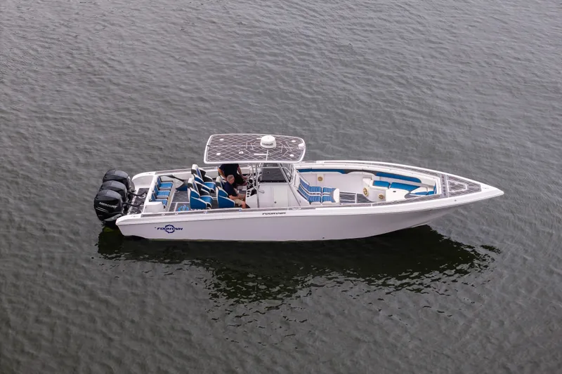 Slide: The Image of 2018 Fountain 38 Center Console boat on water, featuring triple Mercury outboard engines. - 5
