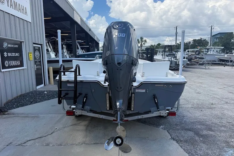 Slide: The Image of 2027 Blazer PureBay 2200 boat with Yamaha engine at dealership. - 10