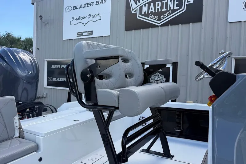 Slide: The Image of 2027 Blazer PureBay 2200 boat interior with seating and steering wheel, displayed at West Coast Marine. - 6