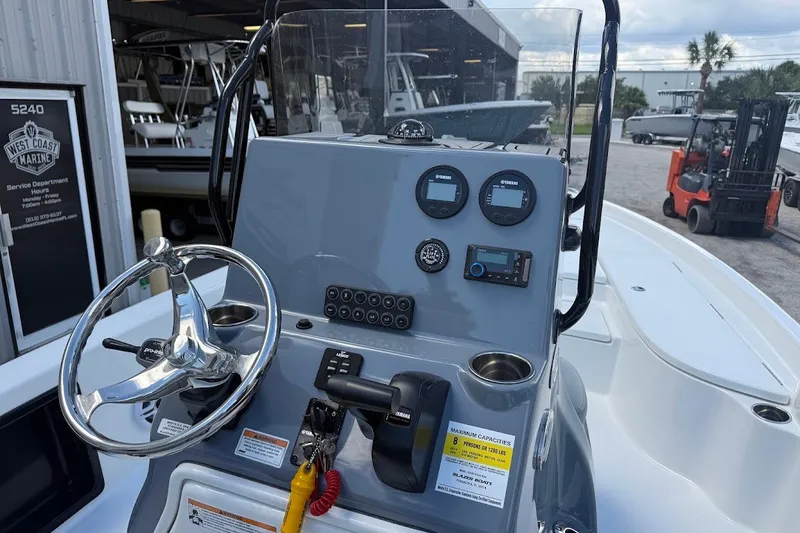 Slide: The Image of 2027 Blazer PureBay 2200 boat dashboard with steering wheel and control panel. - 14