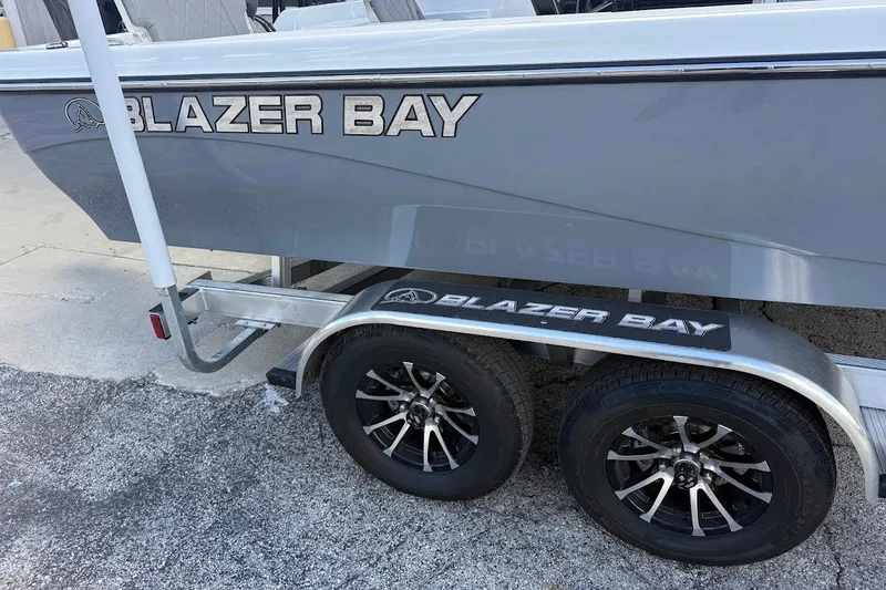 Slide: The Image of 2027 Blazer PureBay 2200 boat on trailer with black alloy wheels. - 8