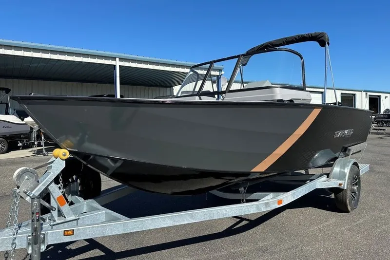 The Image of 2026 Starweld 18 SXR Sport boat on trailer, sleek design, parked outdoors. - 1