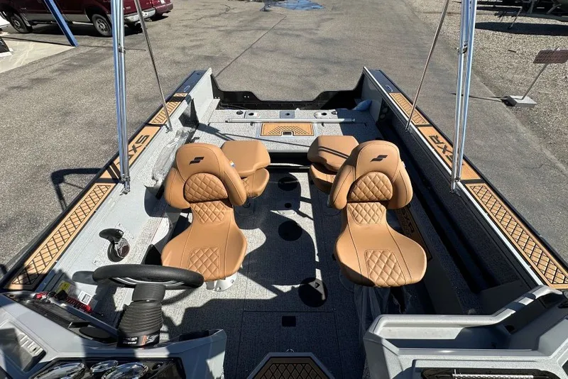 Slide: The Image of 2026 Starweld 18 SXR Sport boat interior with tan seats and modern dashboard. - 6