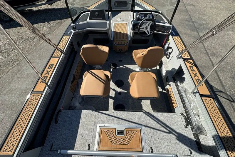 Slide: The Image of 2026 Starweld 18 SXR Sport boat interior with tan seats and modern dashboard. - 4