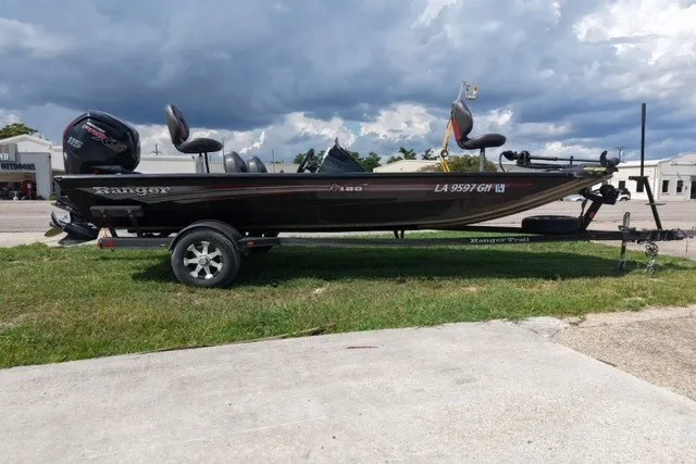 The Image of 2018 Ranger RT188 boat on trailer, parked on grass under cloudy sky. - 0