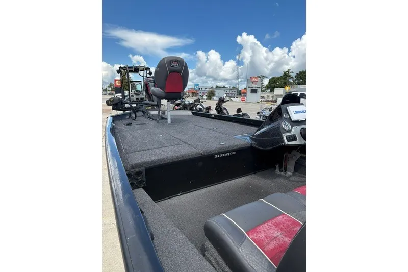 Slide: The Image of 2018 Ranger RT188 fishing boat with seating and control panel, parked outdoors. - 9