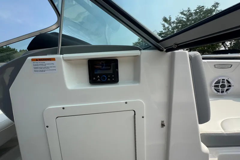 Slide: The Image of Interior view of 2023 Chaparral 21 SSi boat, featuring control panel and seating area. - 24