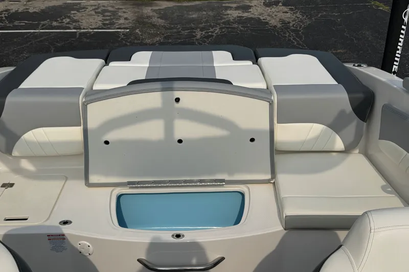 Slide: The Image of 2023 Chaparral 21 SSi boat interior with cushioned seating and storage compartment. - 34