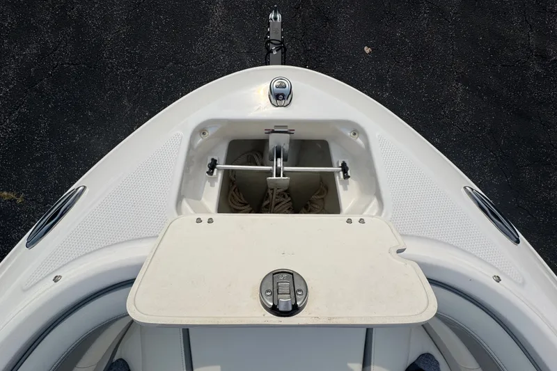 Slide: The Image of 2023 Chaparral 21 SSi boat bow with anchor storage compartment open. - 18