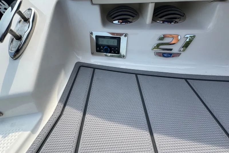 Slide: The Image of 2023 Chaparral 21 SSi boat interior with radio and emblem details. - 36