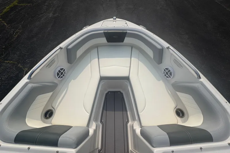 Slide: The Image of 2023 Chaparral 21 SSi boat interior with white and gray seating, featuring speakers and cup holders. - 14