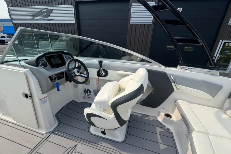 Slide: The Image of 2023 Chaparral 21 SSi boat interior with steering wheel and seating. - 27
