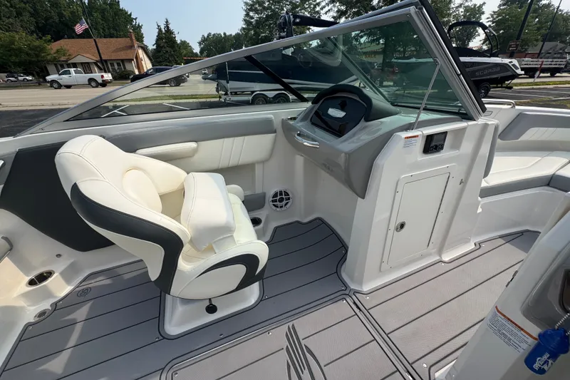 Slide: The Image of 2023 Chaparral 21 SSi boat interior with steering wheel and seating. - 28