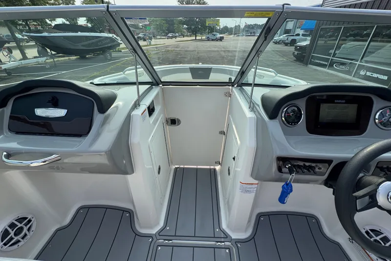 Slide: The Image of 2023 Chaparral 21 SSi boat interior with modern dashboard and steering wheel. - 19